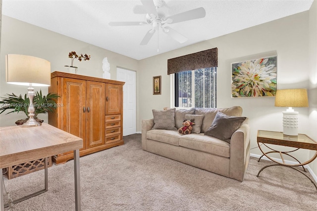 carpeted living room with ceiling fan