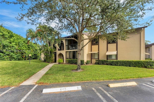 442 Pine Glen Ln Unit D-2, Green Acres, FL 33463 - view of property featuring uncovered parking