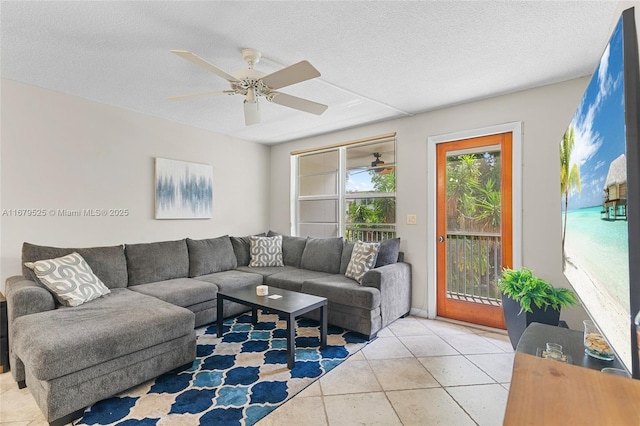 tiled living room featuring ceiling fan and a textured ceiling