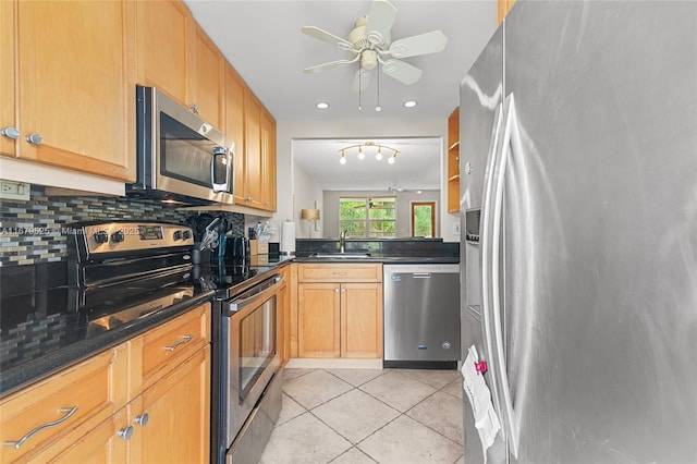 kitchen with stainless steel appliances, sink, backsplash, ceiling fan, and light tile patterned floors