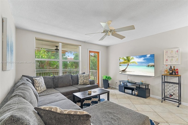 tiled living room with a textured ceiling and ceiling fan