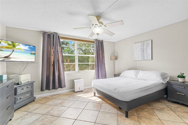 tiled bedroom featuring ceiling fan and a textured ceiling