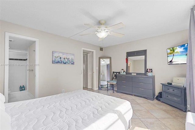 tiled bedroom featuring ceiling fan and a textured ceiling