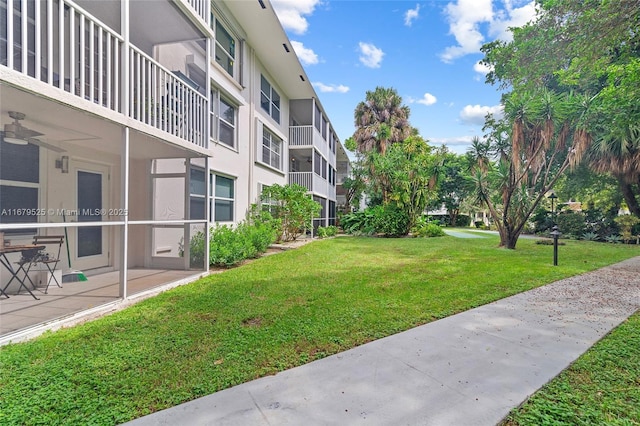 view of community with a lawn and a patio