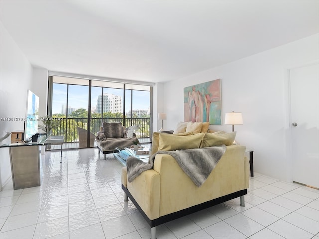 living room with light tile patterned floors and a wall of windows