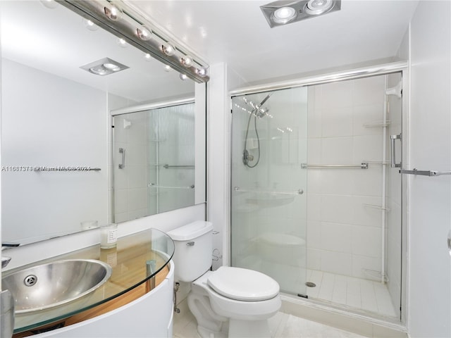 bathroom featuring a shower with door, toilet, tile patterned flooring, and vanity