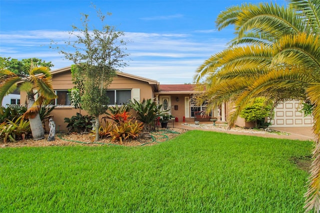 view of front facade featuring a front lawn and a garage