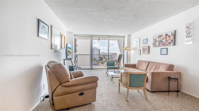 living room with carpet floors, a textured ceiling, and floor to ceiling windows