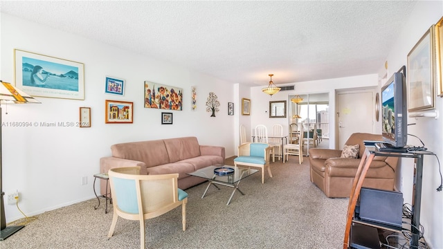 carpeted living room with a textured ceiling