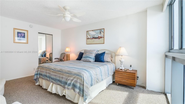 bedroom featuring carpet, a textured ceiling, a closet, and ceiling fan