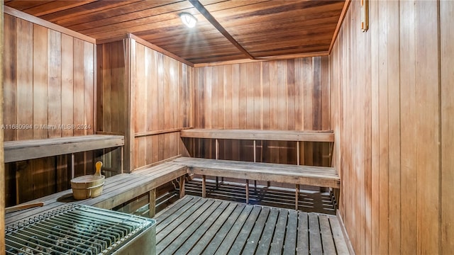 view of sauna featuring wood walls and wooden ceiling