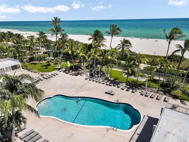 view of pool with a water view and a view of the beach