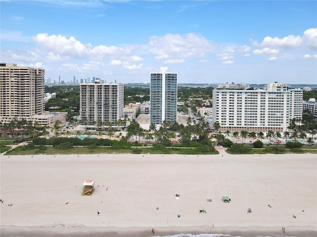 drone / aerial view featuring a view of the beach and a water view