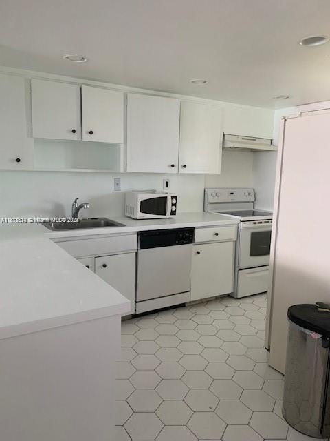 kitchen featuring white appliances and white cabinets