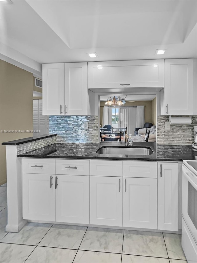 kitchen with sink, white cabinetry, and decorative backsplash