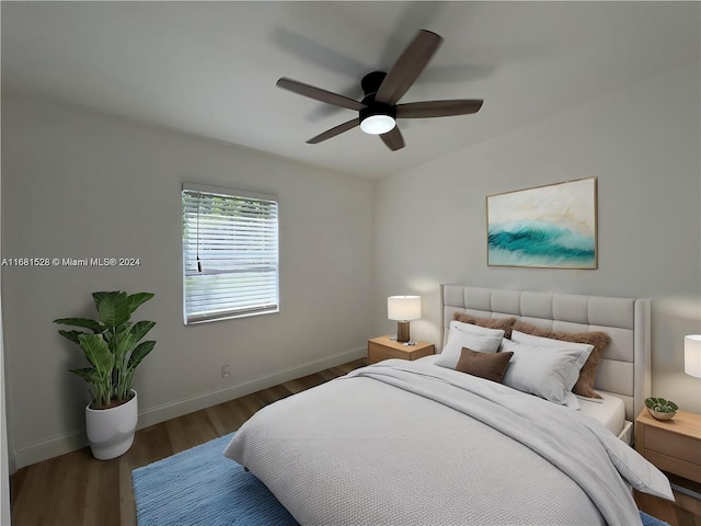 bedroom with ceiling fan and dark hardwood / wood-style flooring