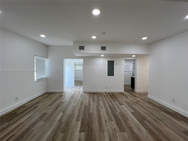 empty room with electric panel and dark wood-type flooring