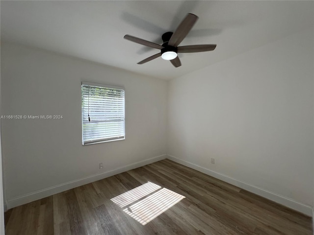 spare room featuring ceiling fan and dark hardwood / wood-style flooring