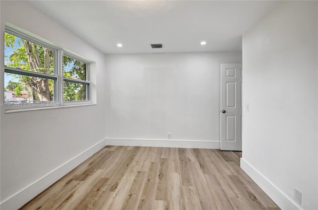 empty room with light hardwood / wood-style floors