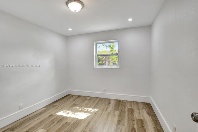 spare room with light hardwood / wood-style flooring