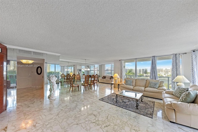 living room featuring a textured ceiling and floor to ceiling windows