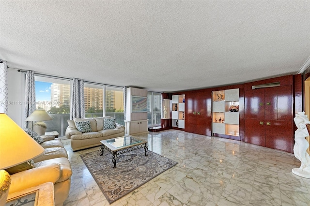 living room featuring expansive windows and a textured ceiling