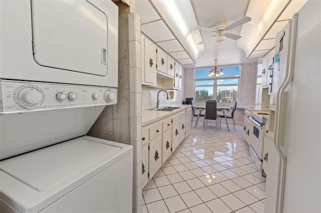 kitchen featuring white fridge with ice dispenser, sink, white cabinetry, stacked washer / drying machine, and range with electric stovetop