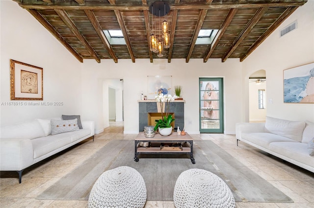 living room with beam ceiling, wooden ceiling, and high vaulted ceiling