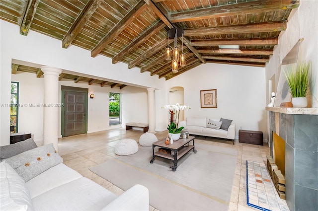 living room featuring beam ceiling, ornate columns, and wood ceiling