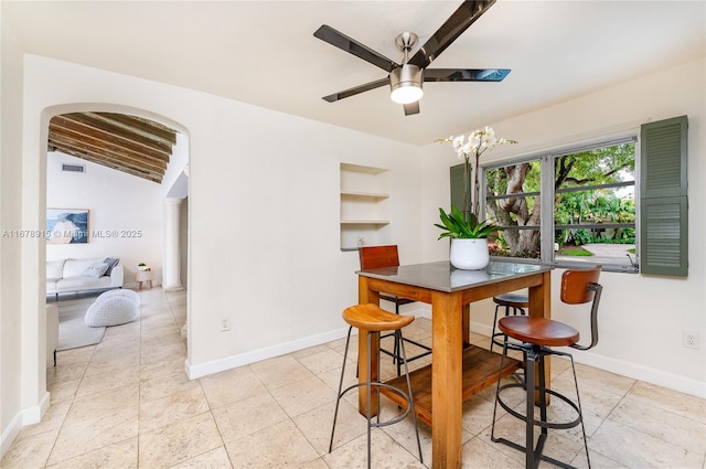 dining room featuring vaulted ceiling with beams and ceiling fan