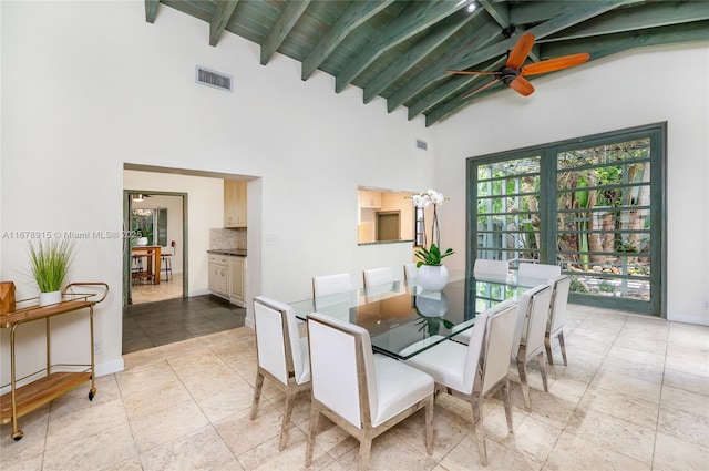 dining room with beam ceiling, ceiling fan, french doors, wooden ceiling, and high vaulted ceiling