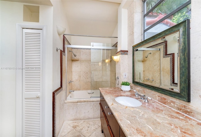 bathroom featuring vanity and tiled shower / bath