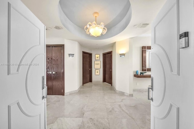 hallway with a raised ceiling