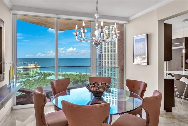 dining space featuring a water view, ornamental molding, and a notable chandelier