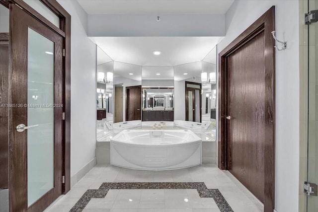 bathroom featuring tile patterned flooring and a bath