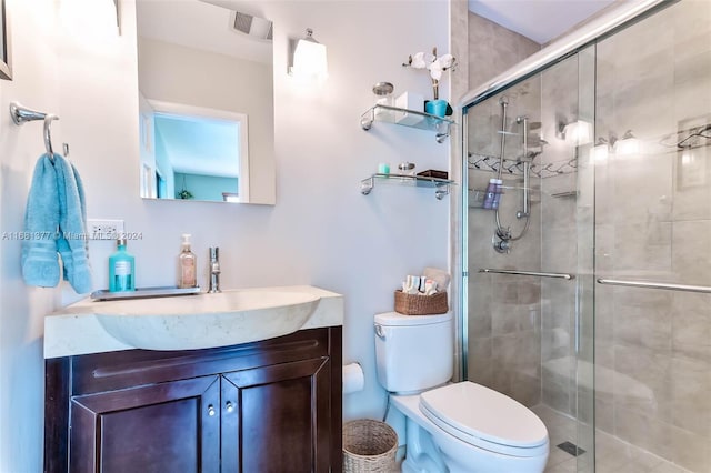 bathroom with toilet, a stall shower, visible vents, and vanity