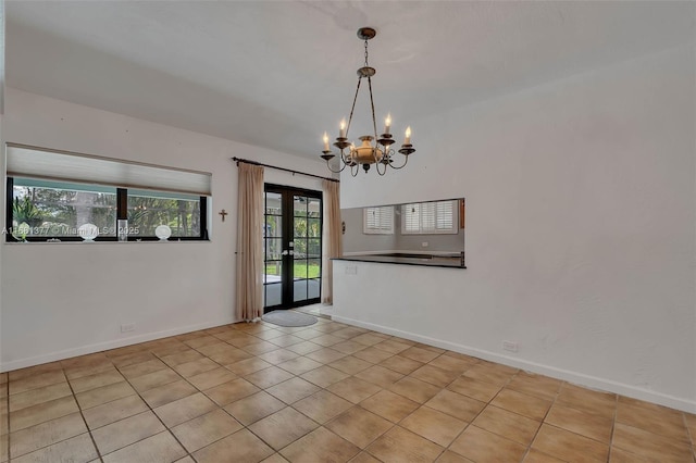 7901 SW 133rd St, Pinecrest, FL 33156 - tiled empty room featuring french doors and a chandelier