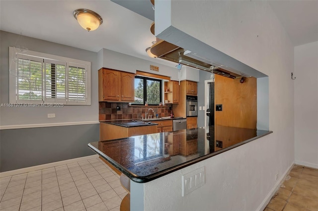7901 SW 133rd St, Pinecrest, FL 33156 - kitchen featuring stainless steel appliances, backsplash, light tile patterned flooring, a peninsula, and brown cabinets