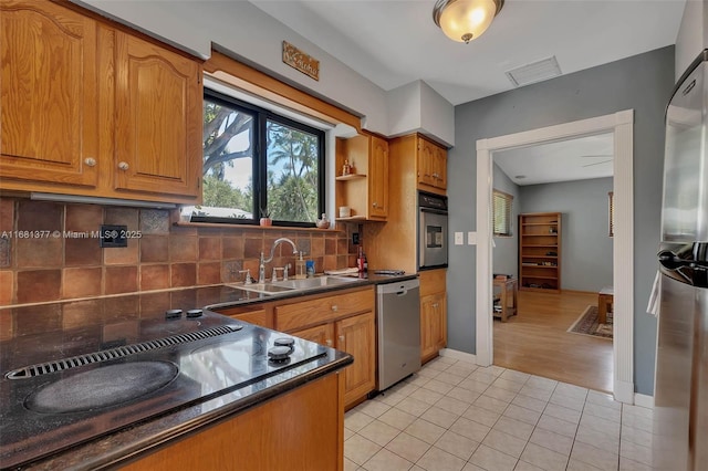 7901 SW 133rd St, Pinecrest, FL 33156 - kitchen with appliances with stainless steel finishes, dark countertops, backsplash, light tile patterned floors, and brown cabinetry