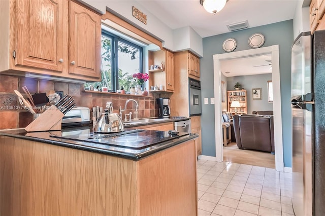 kitchen with tasteful backsplash, stainless steel appliances, light tile patterned floors, a sink, and visible vents