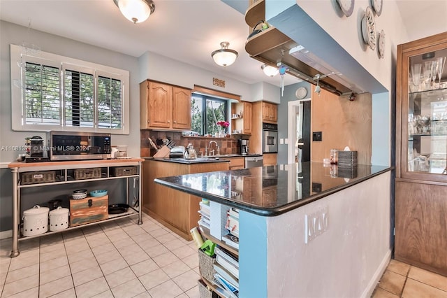 kitchen with light tile patterned floors, open shelves, stainless steel appliances, dark countertops, and a sink