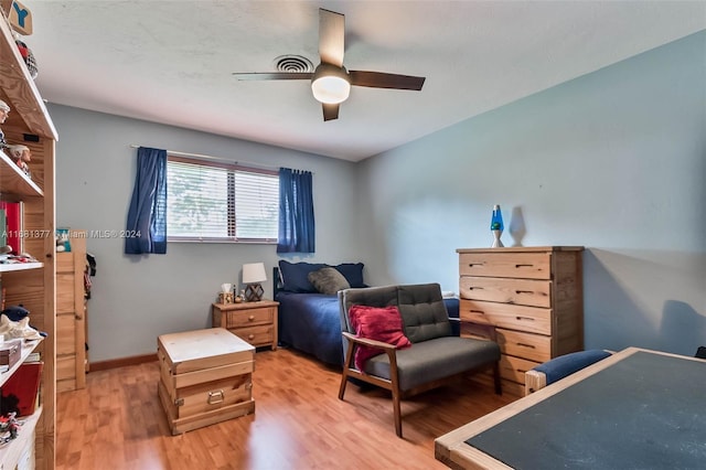bedroom featuring ceiling fan, light wood finished floors, and baseboards