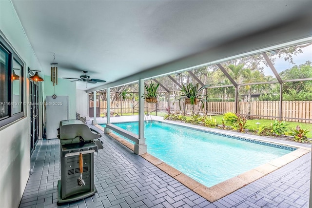 7901 SW 133rd St, Pinecrest, FL 33156 - view of swimming pool with area for grilling, a fenced backyard, a ceiling fan, a patio area, and a lanai