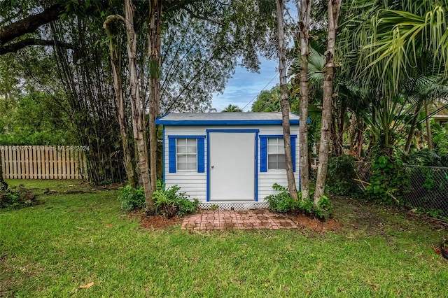 view of shed featuring fence