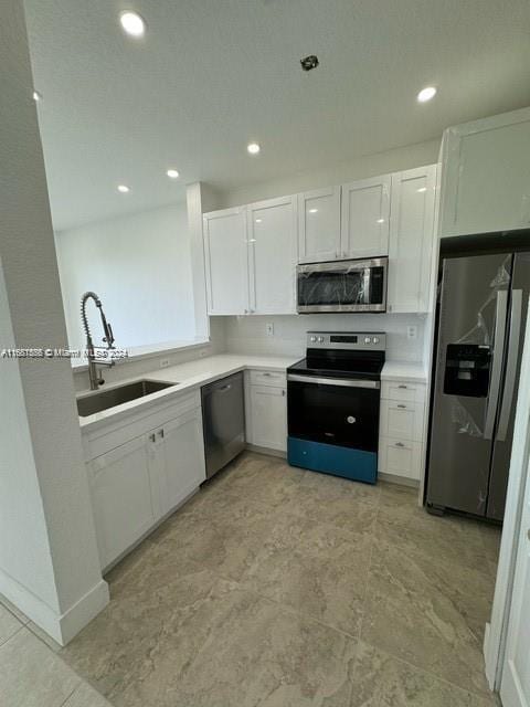 kitchen featuring white cabinetry, appliances with stainless steel finishes, and sink