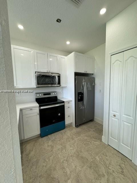 kitchen featuring appliances with stainless steel finishes and white cabinetry