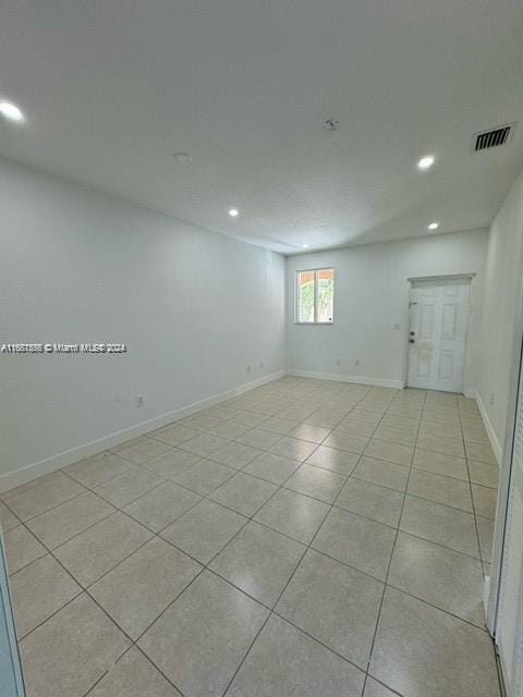 empty room with light tile patterned flooring