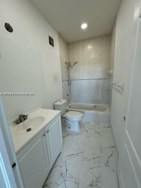 full bathroom featuring vanity, toilet, and tiled shower / bath combo