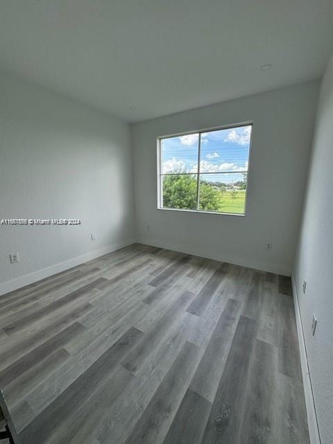 unfurnished room featuring hardwood / wood-style floors