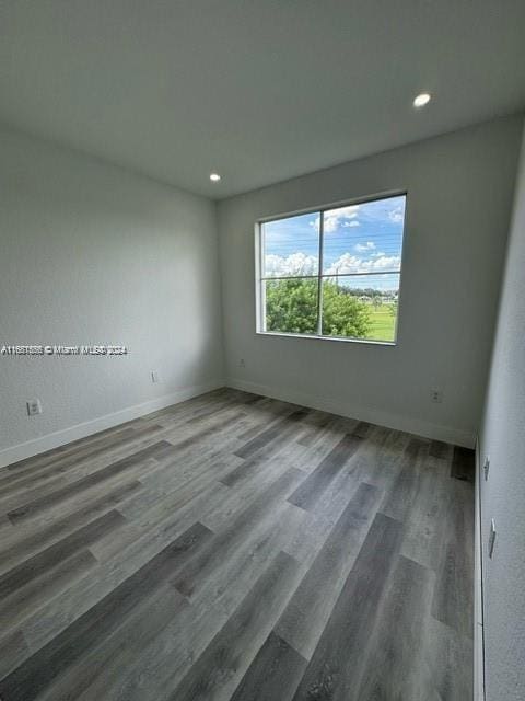 unfurnished room featuring hardwood / wood-style flooring